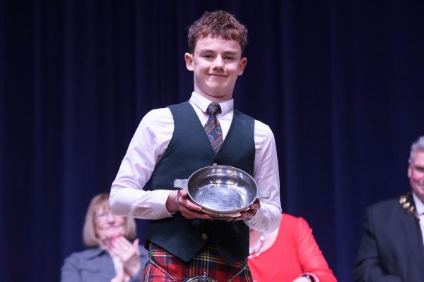 Louis O' Rourke being present with a trophy by Angela Docherty (Provost’s wife) at Inverclyde Music Festival Awards